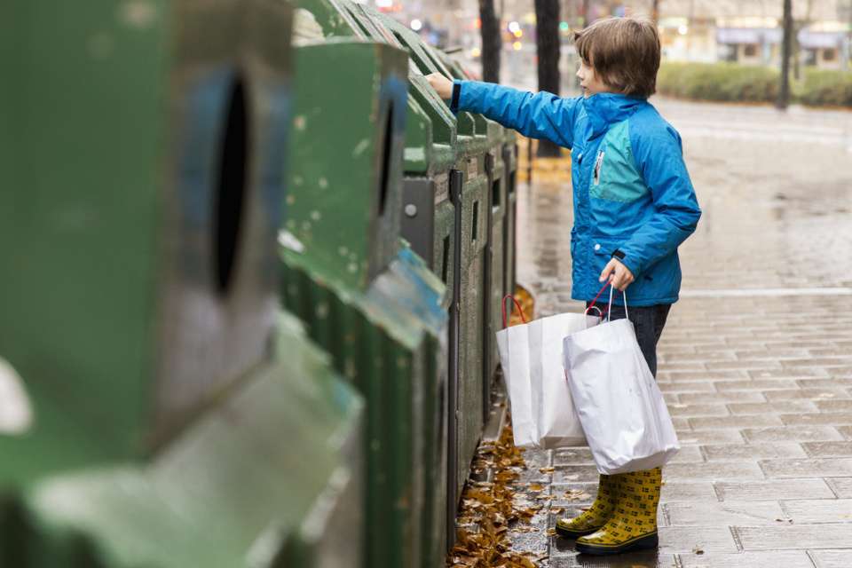 boy at recycling station